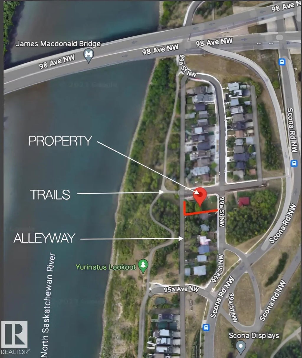 Aerial view of 9556 99A Street NW Edmonton — the property is an end-lot corner with river valley trails immediately to the west and alley access along the south. The James MacDonald Bridge is visible to the north, showing how close downtown Edmonton is.
